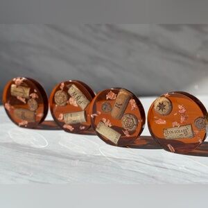 Set of Four Amber Coasters with Wine Cork Design and rose gold leading.